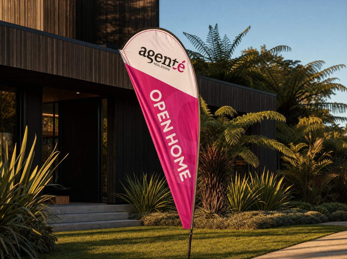 Agenté teardrop Open Home flag outside a modern New Zealand home